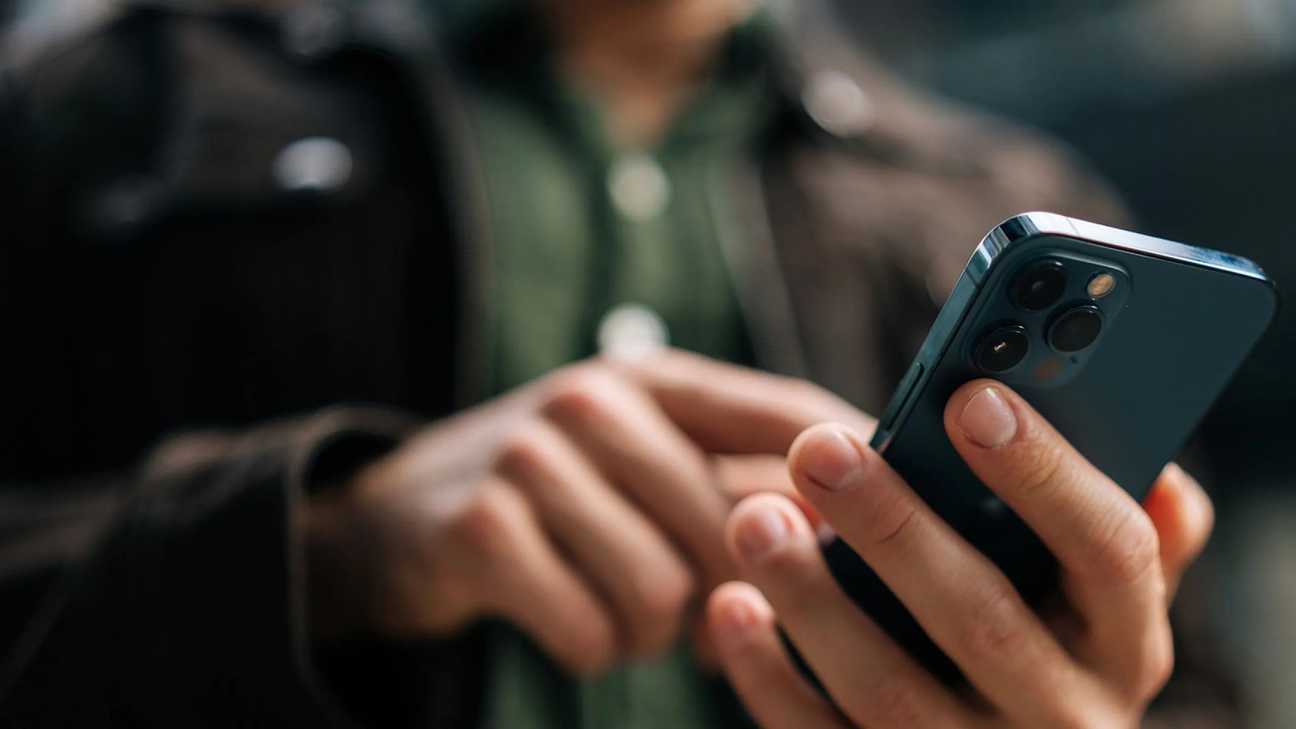 Close-up of a person using a smartphone, reflecting modern connectivity and technology.