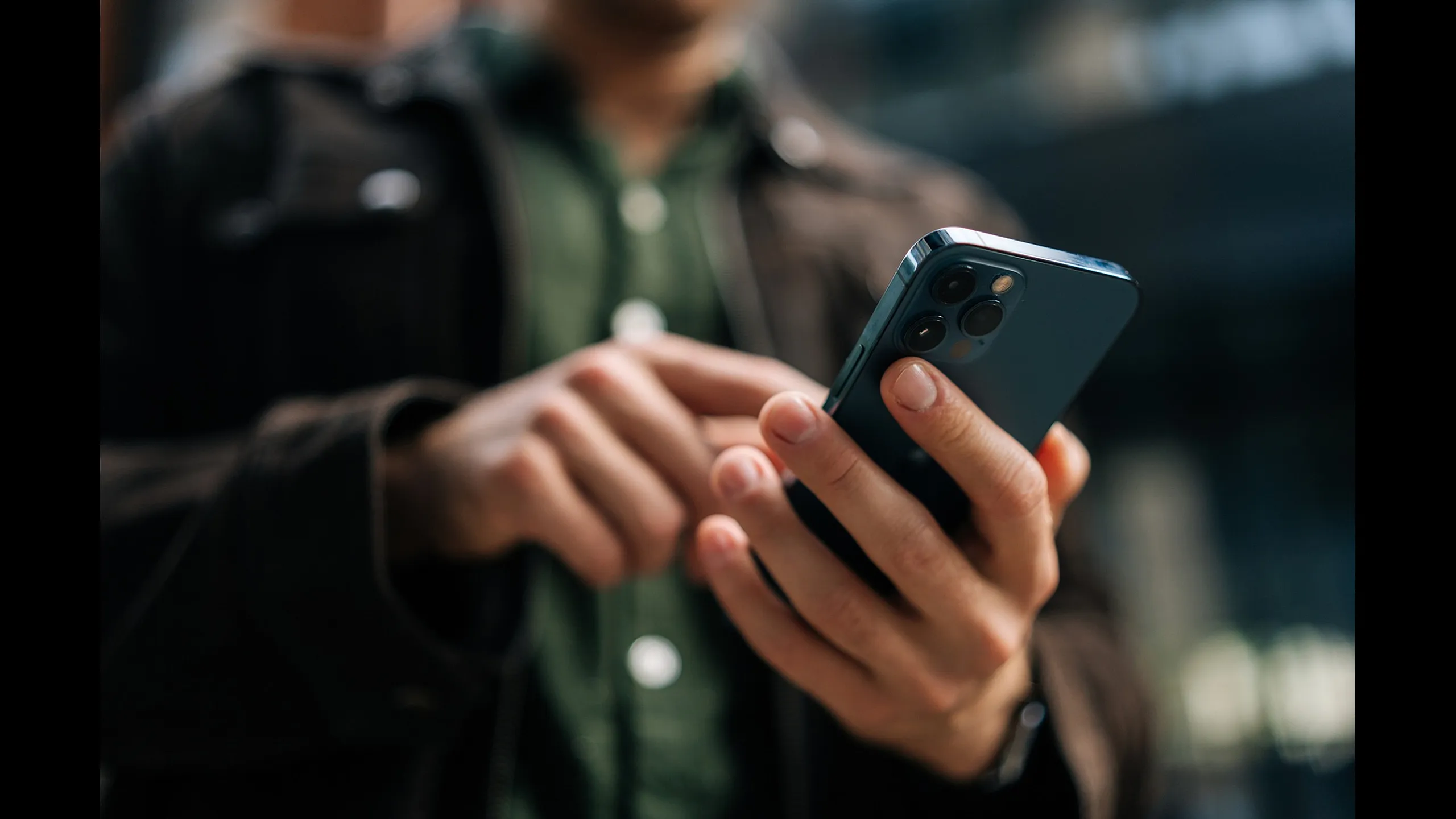 Close-up of a person holding a modern smartphone, showcasing sleek design and advanced camera features.