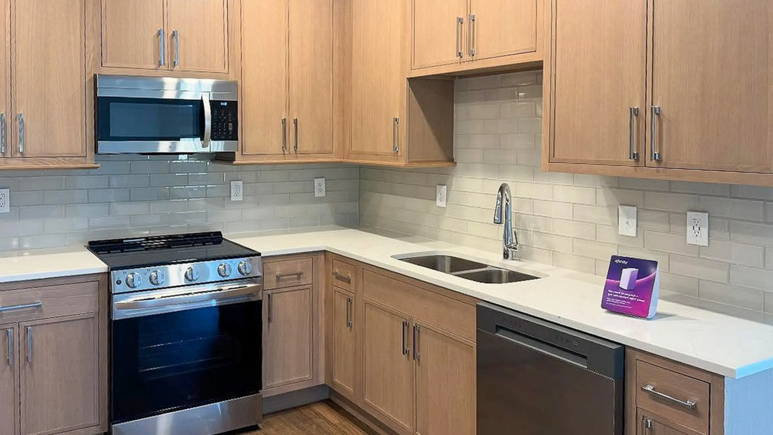 Modern kitchen with sleek stainless steel appliances, elegant wooden cabinetry, and chic subway tile backsplash creating a warm and inviting atmosphere.