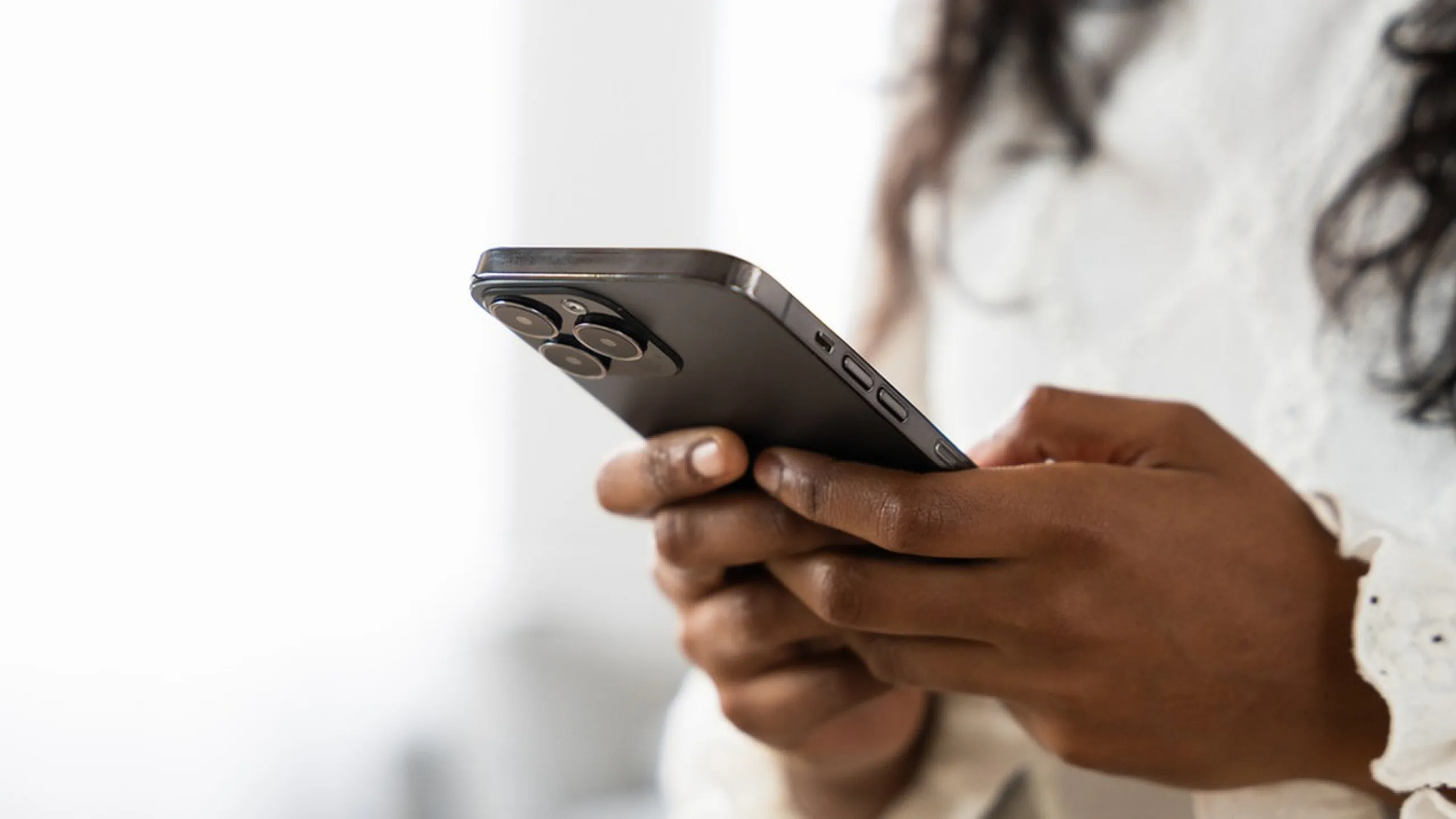 Close-up of a person holding a sleek smartphone, showcasing modern technology and connectivity.