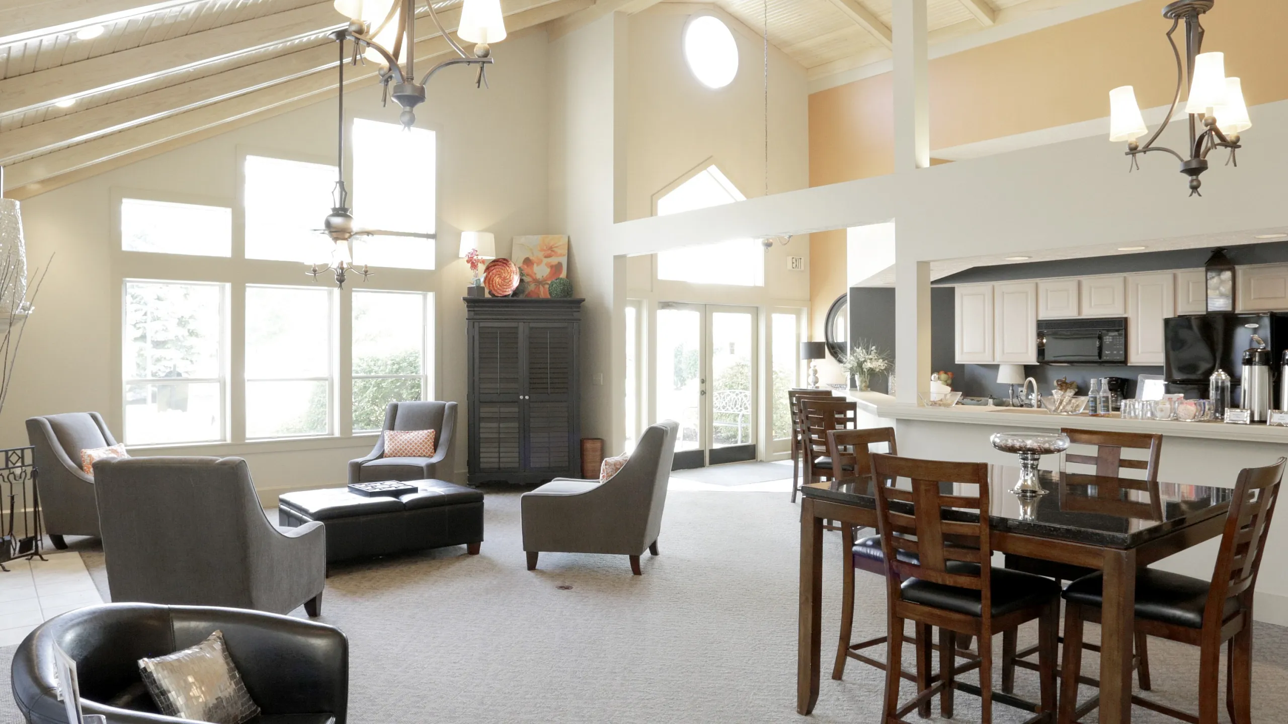 Elegant open-plan living area with high vaulted ceilings, abundant natural light, and stylish modern furniture.