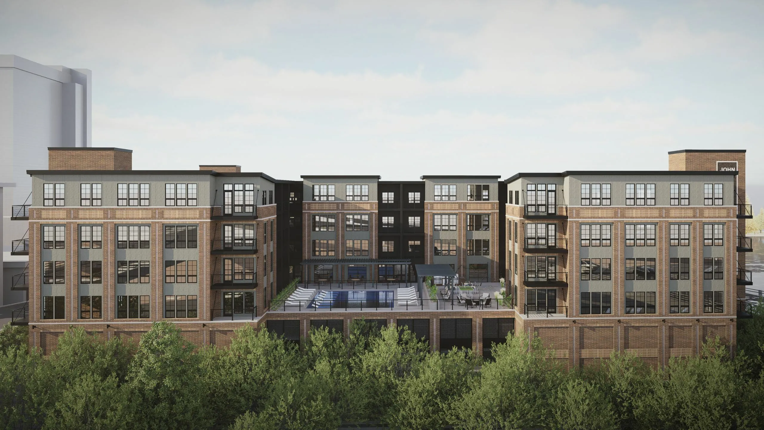 Contemporary brick apartment complex with spacious balconies and an inviting rooftop pool area surrounded by lush greenery.