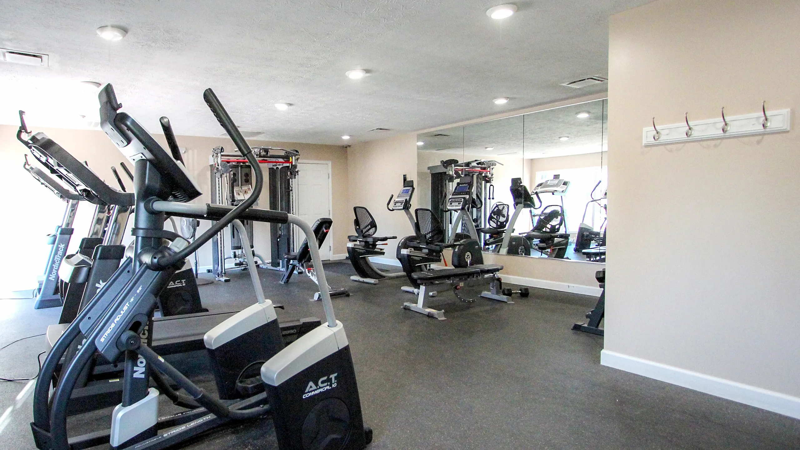 Modern fitness center with state-of-the-art exercise equipment and mirrored walls, perfect for an energizing workout session.