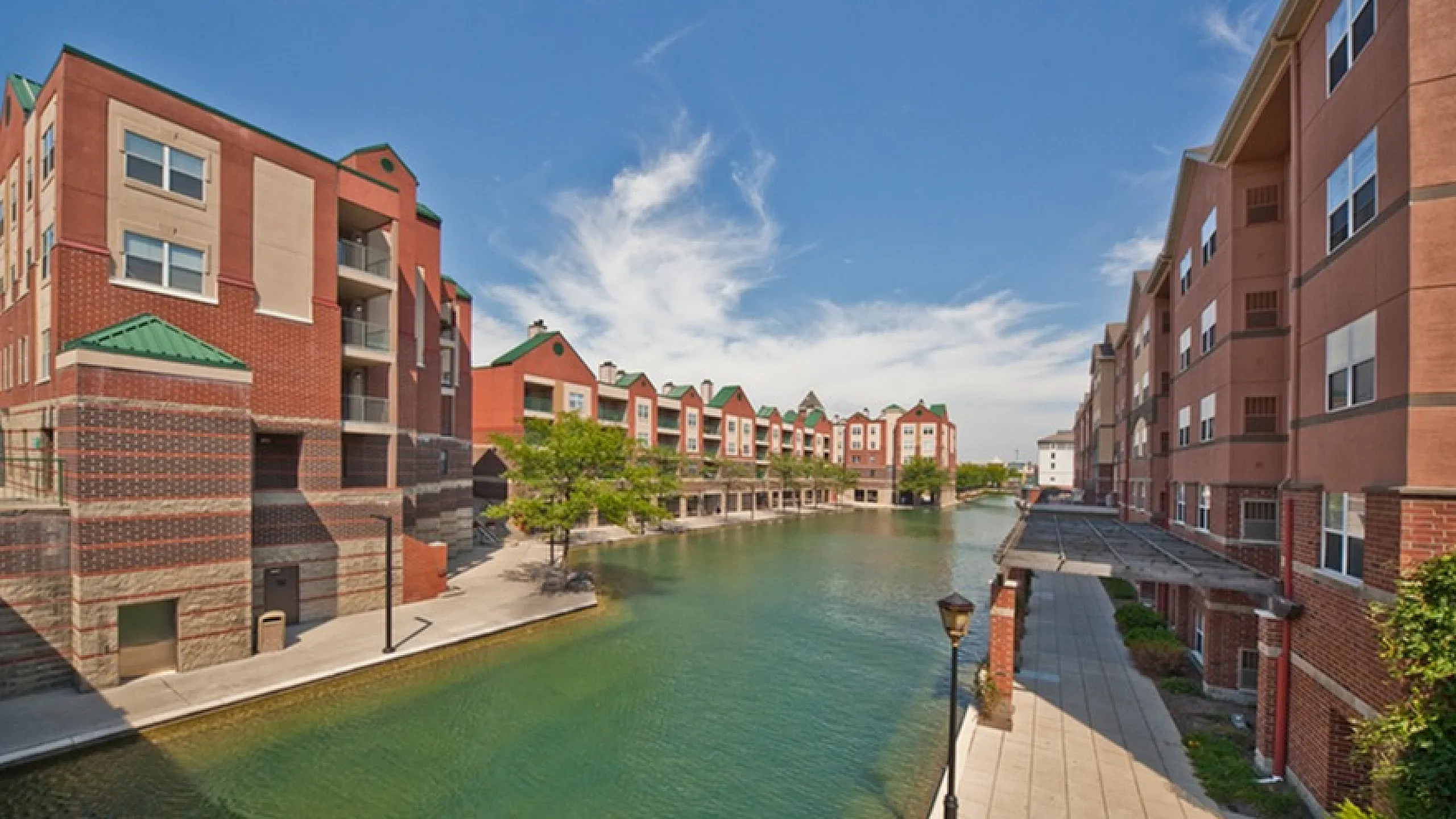 Charming waterfront apartment complex with picturesque views, vibrant architecture, and inviting walkways.
