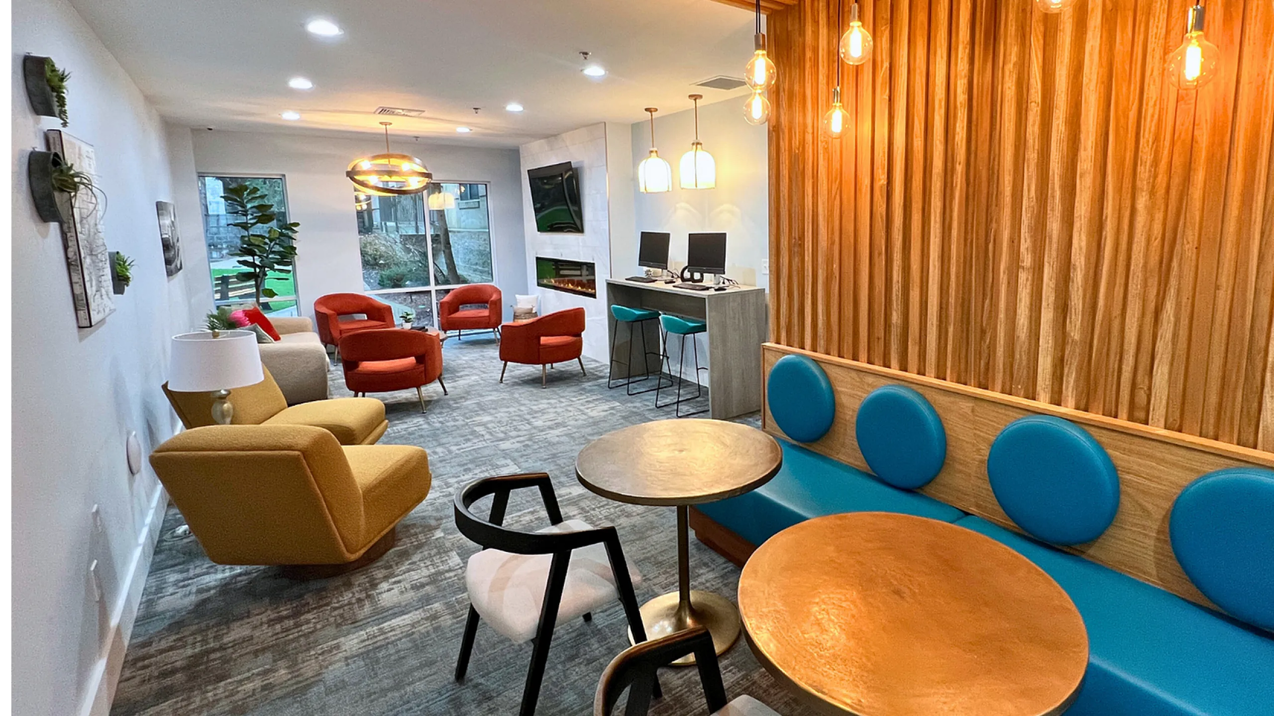 Contemporary lounge with vibrant seating, warm lighting, and stylish wooden accents, perfect for relaxation and social gatherings.