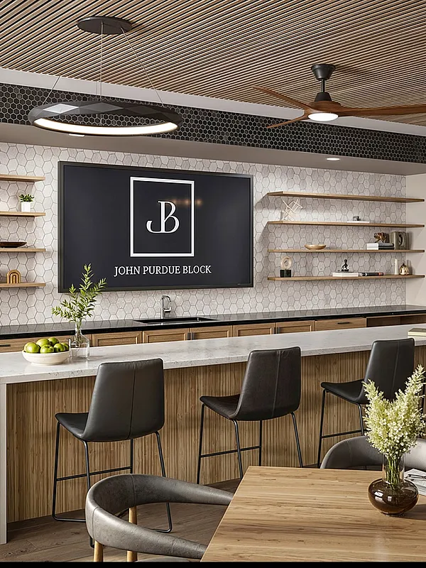 Chic communal space boasting sleek decor, a modern bar area with stylish seating, and elegant shelving with accent pieces.