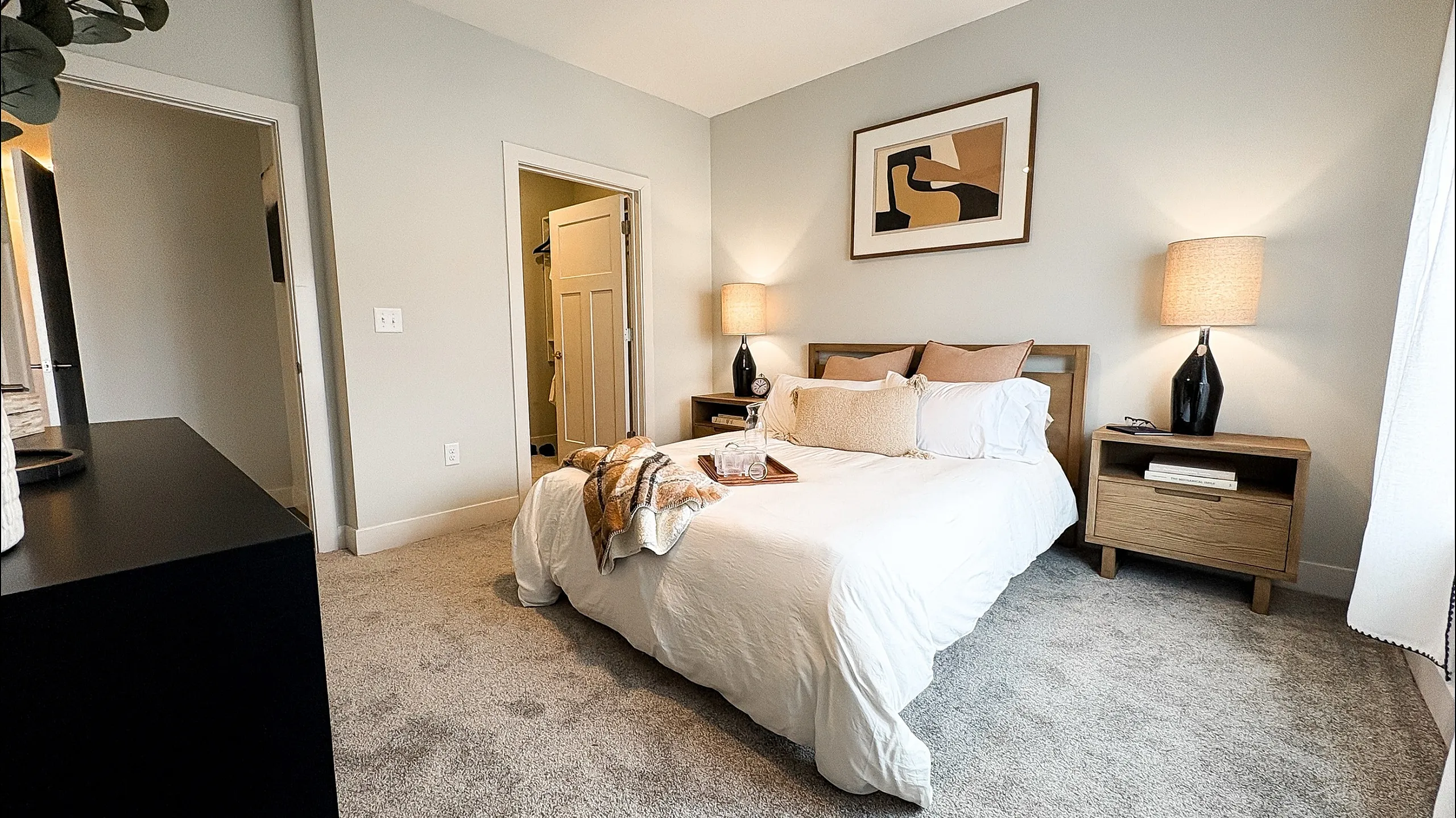 Elegant bedroom with cozy double bed, chic decor, soft lighting, and plush carpet for ultimate comfort.