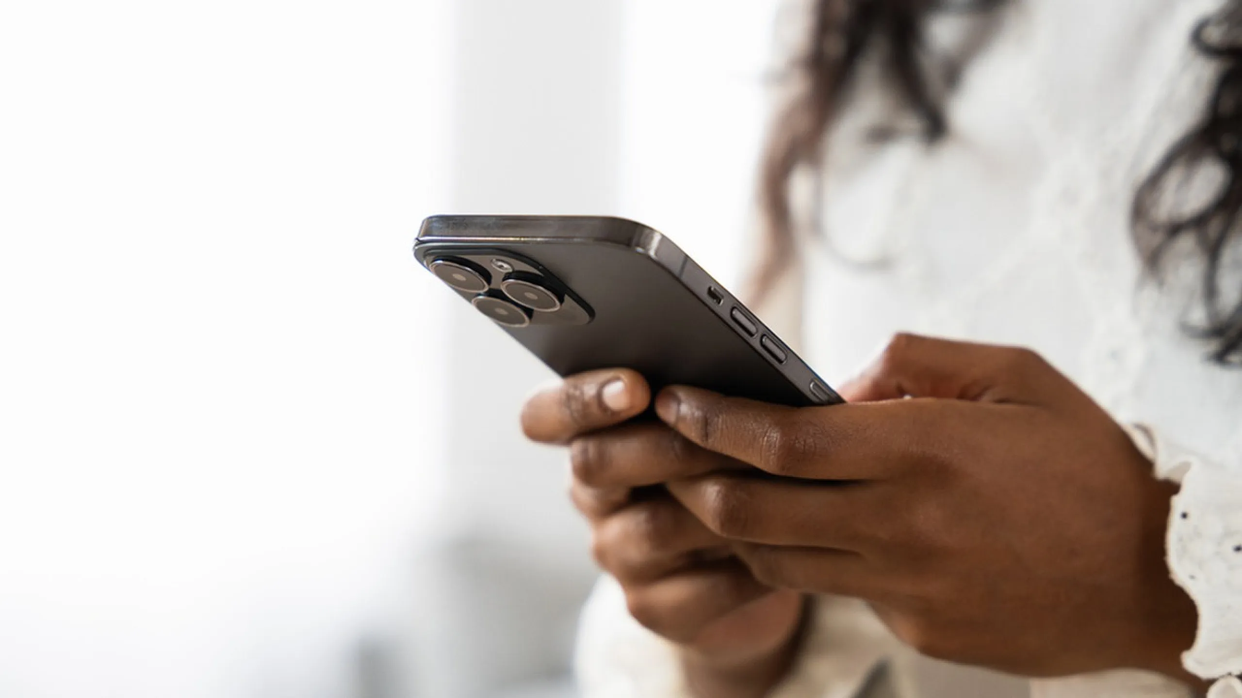 Close-up of a person holding a sleek smartphone, showcasing modern technology and connectivity.
