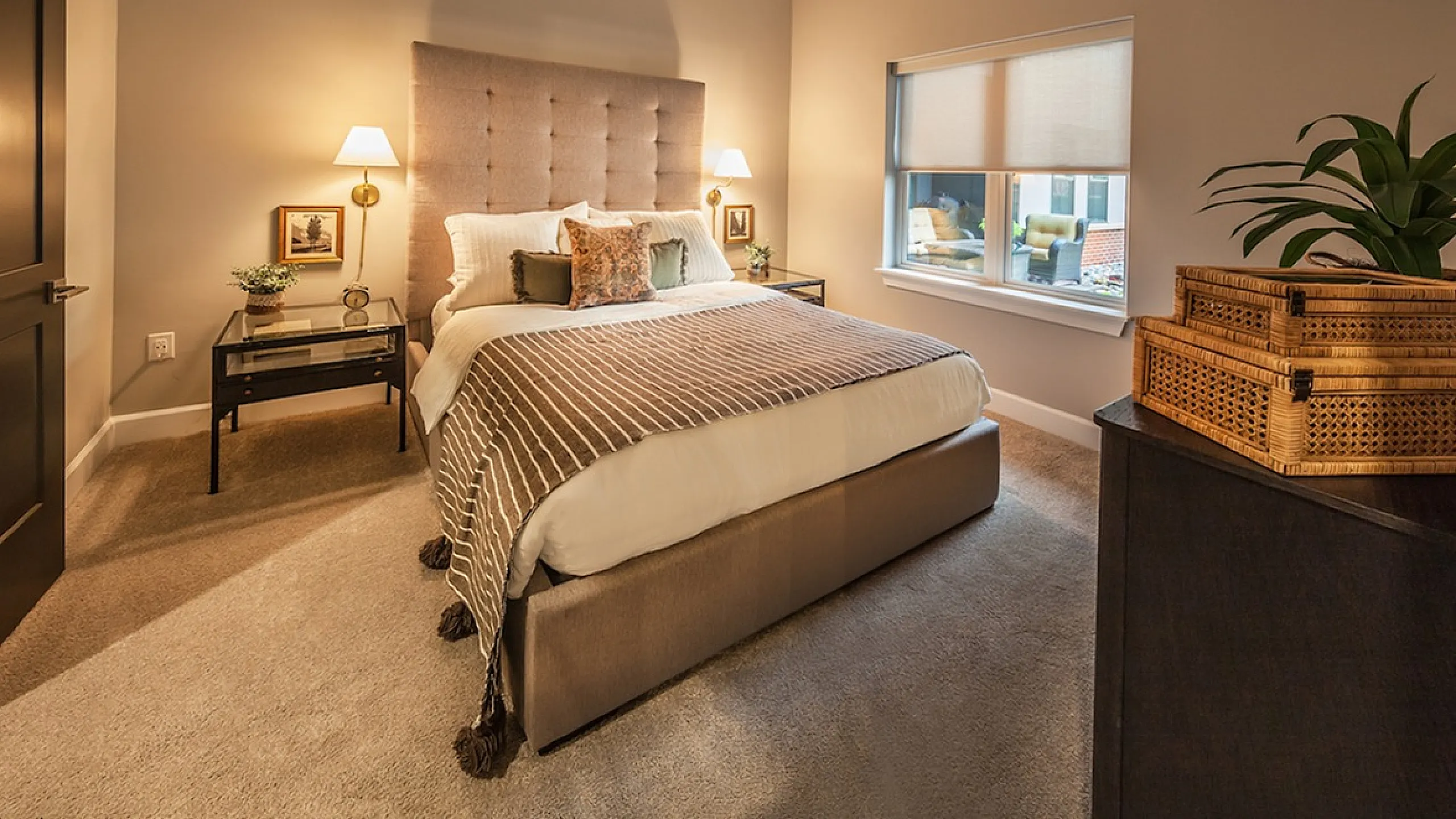 Elegant bedroom with a plush bed, cozy lighting, and modern decor, exuding warmth and comfort.