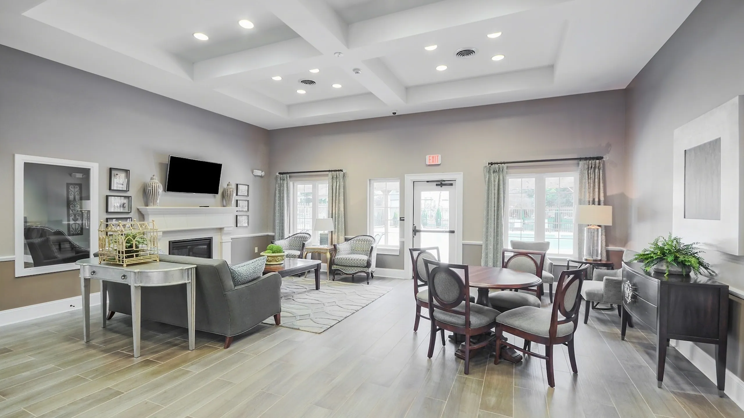 Elegant community room with modern furnishings, stylish seating areas, and large windows inviting natural light.