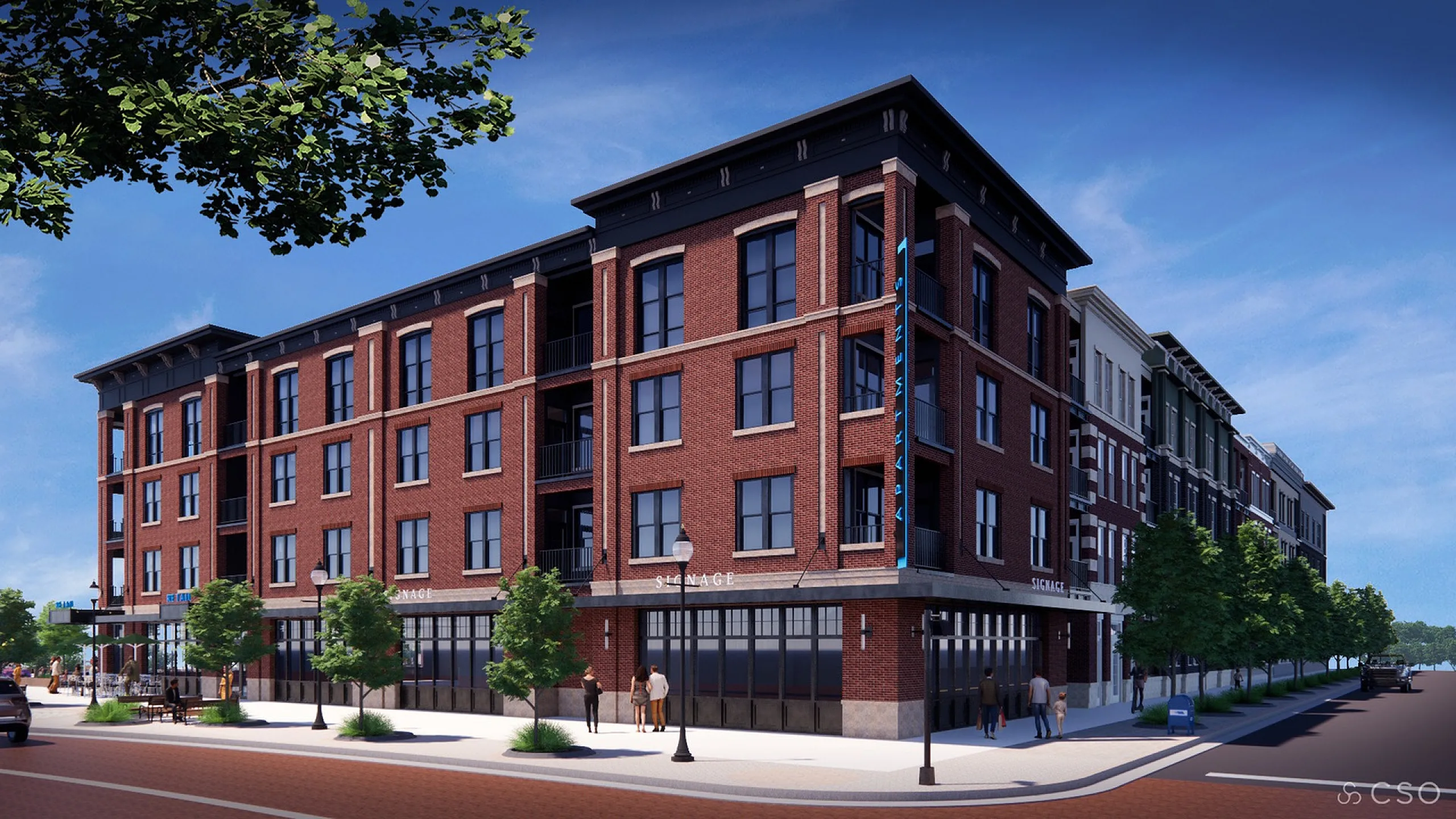 The Vault building with classic brick facade and large windows, nestled on a tree-lined street, offering modern city living.