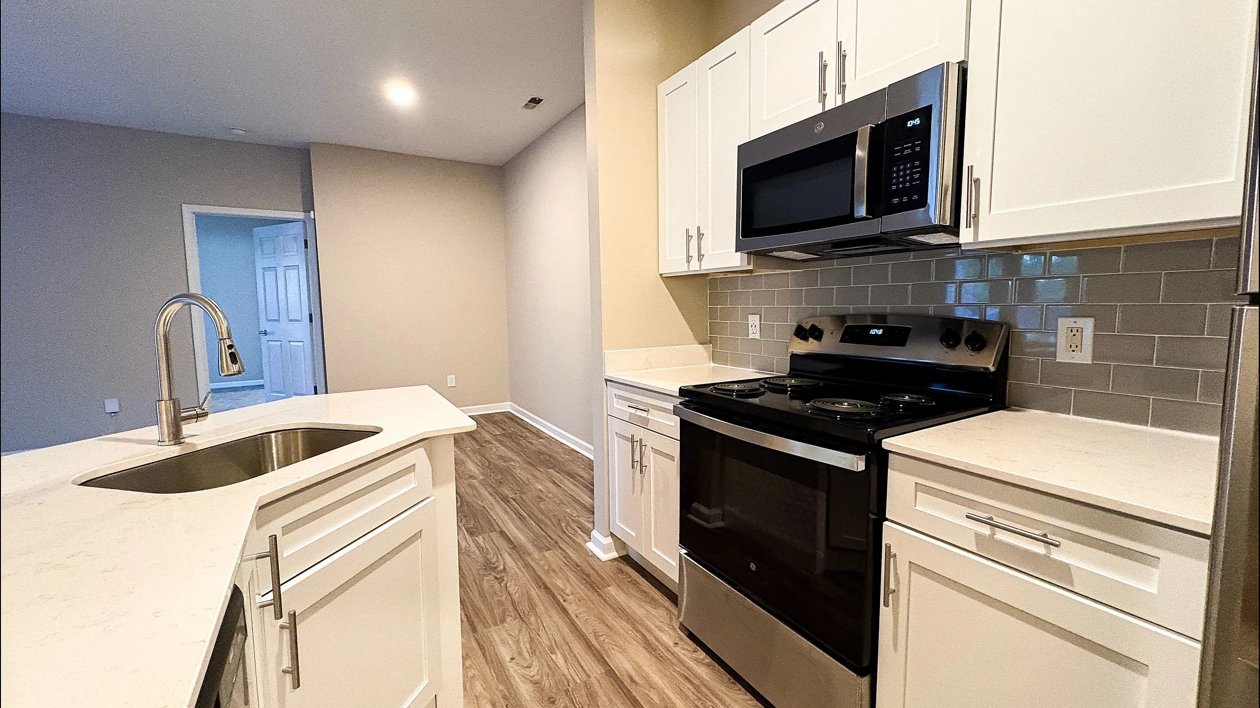 Modern kitchen with sleek appliances, glossy countertops, and stylish cabinetry, perfect for culinary creativity.