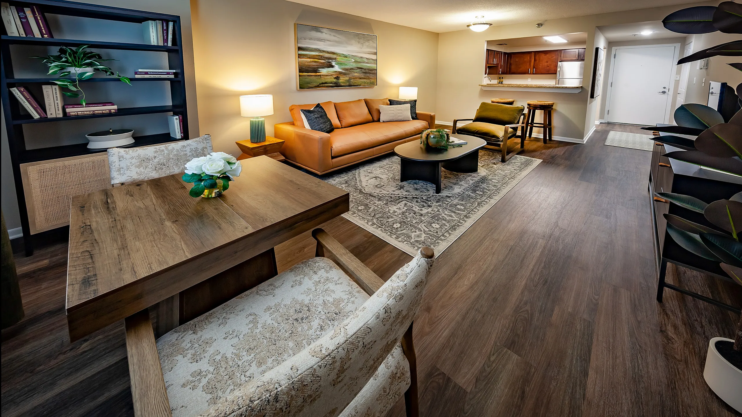 Luxurious open-concept living room with elegant wood flooring, stylish modern furniture, and a cozy ambiance perfect for relaxation and entertaining.