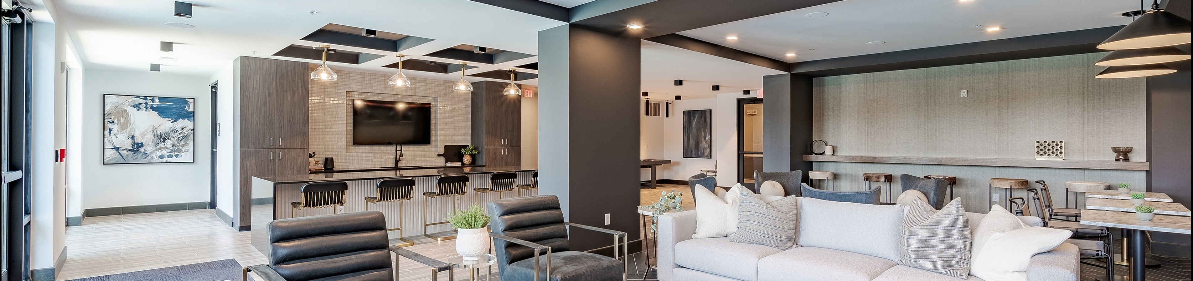 Federal Hill Luxurious modern lounge area featuring sleek seating, elegant lighting fixtures, and an open-layout view for social gatherings.