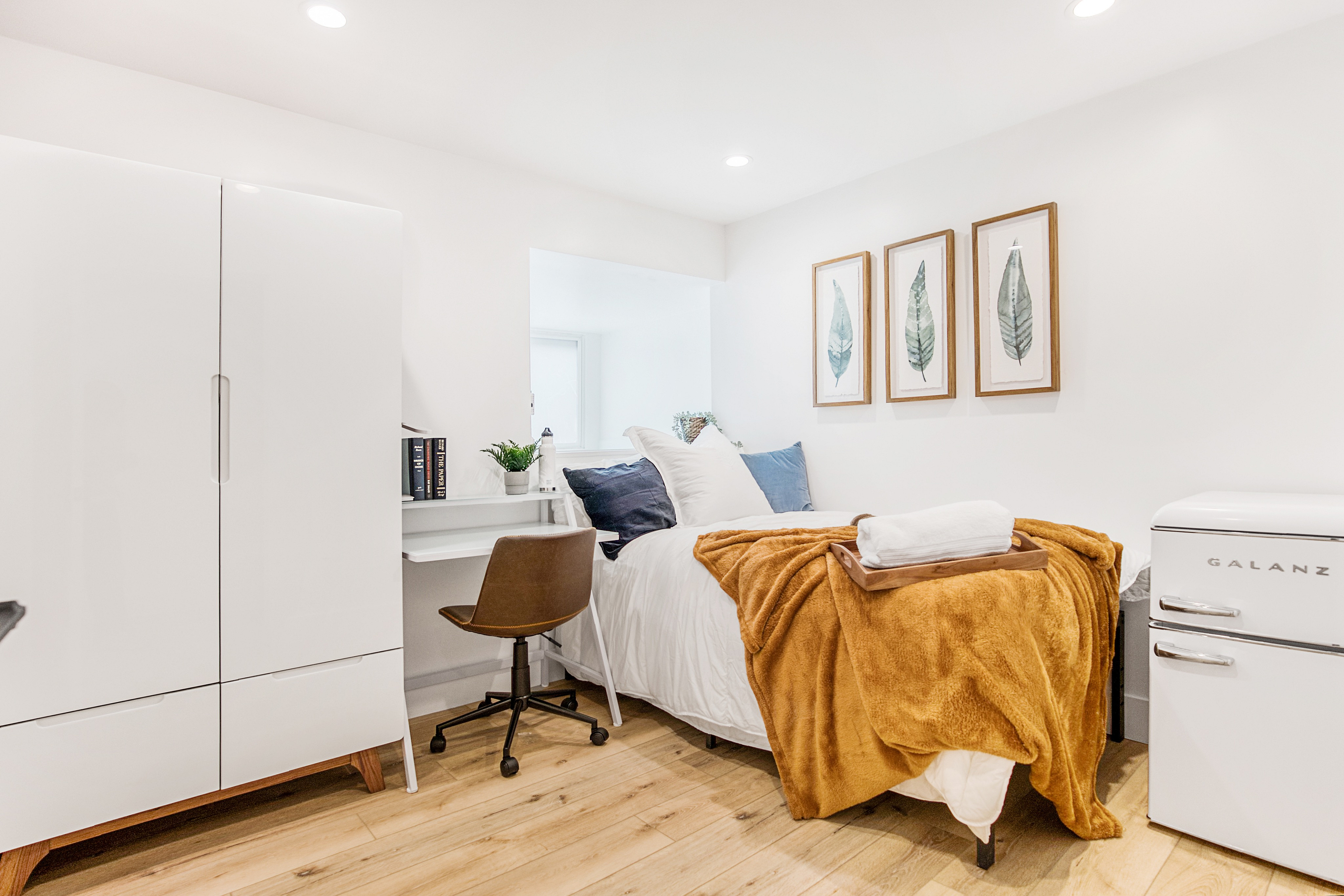 Bright single bedroom equipped with mini fridge