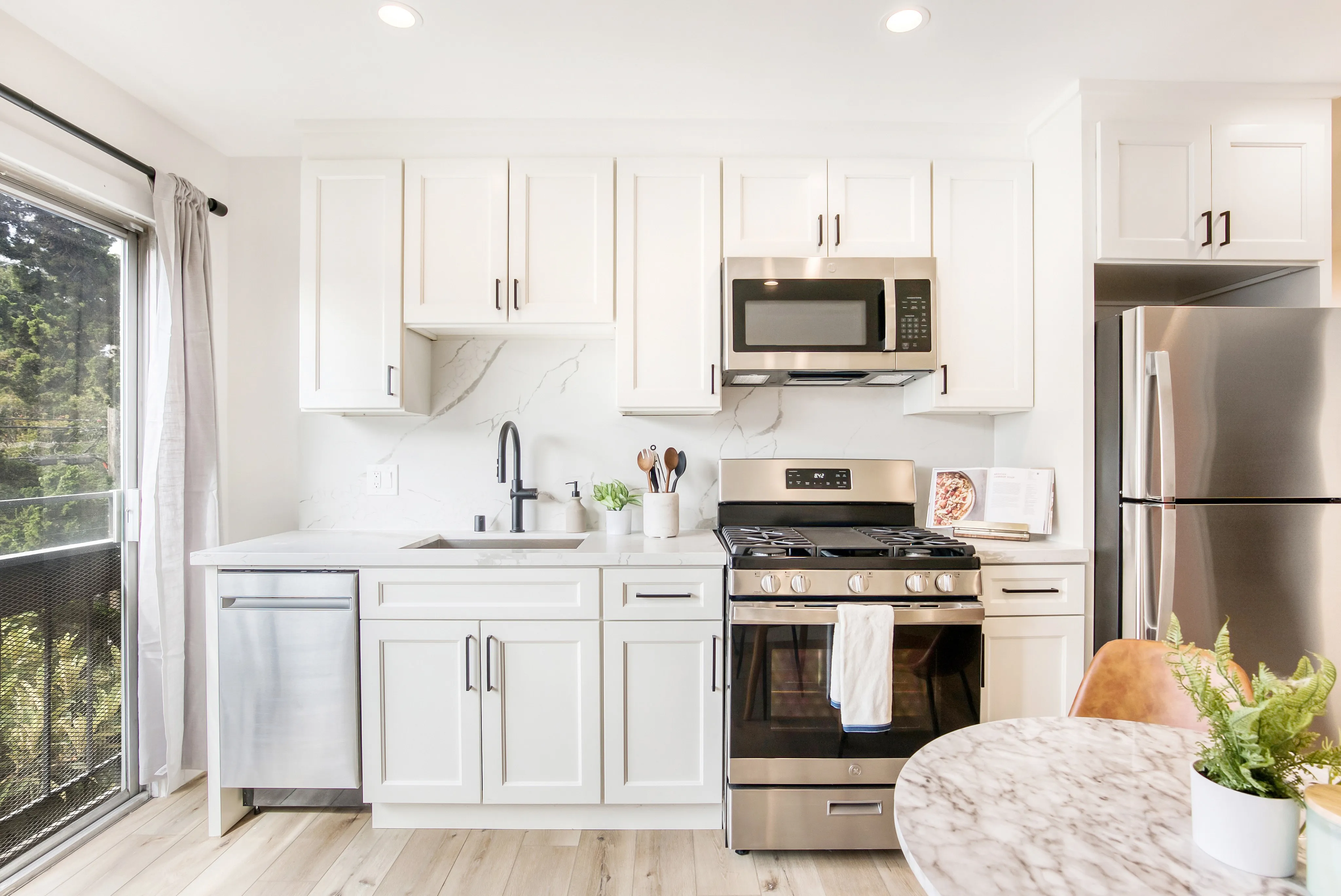 Open concept with stainless steel appliances and natural lighting