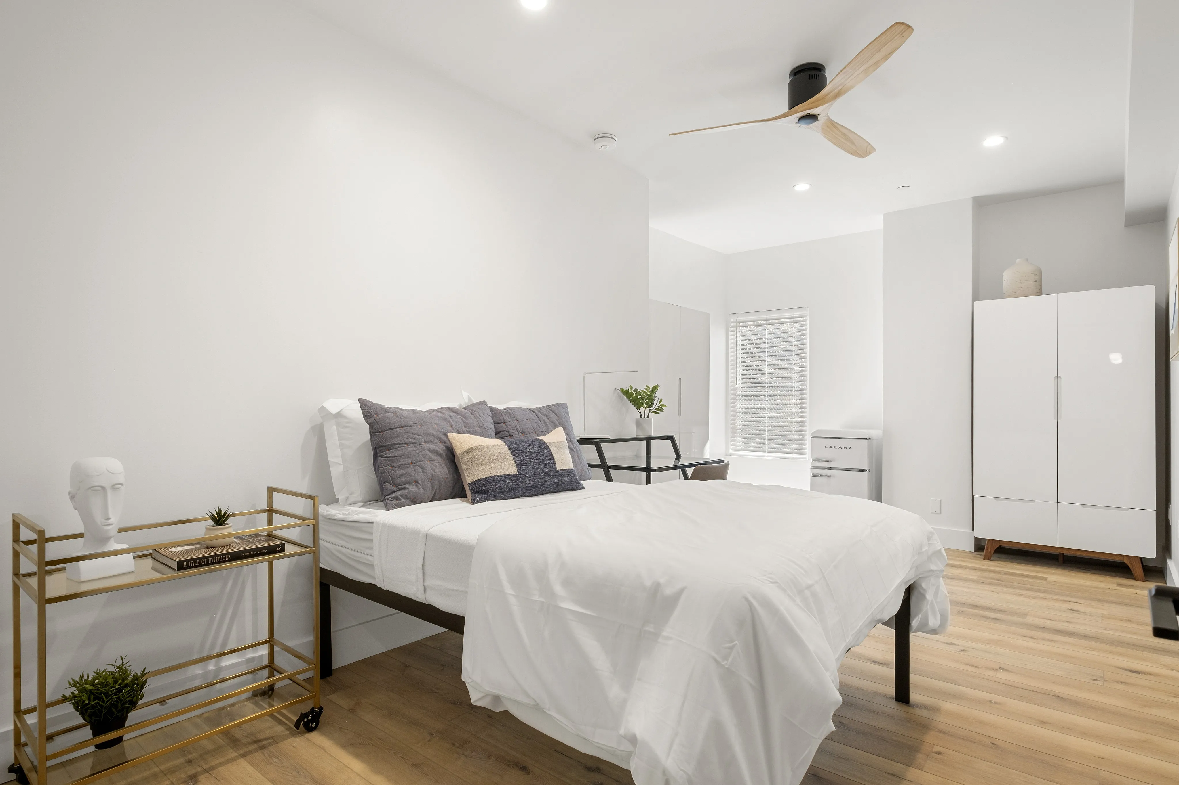Fully furnished bedrooms include a bed, closet, microwave and refrigerator.