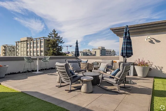 Luxurious rooftop terrace featuring stylish seating, modern decor, and breathtaking city views, perfect for relaxation and entertaining.