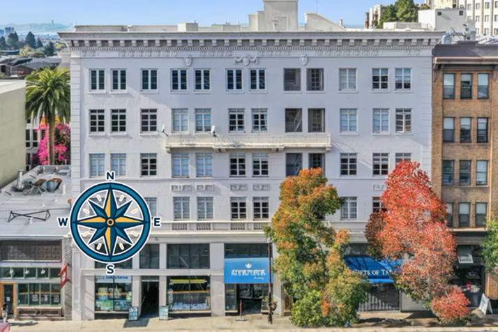 Elegant urban apartment building facade with charming autumn-colored trees and bustling street view.
