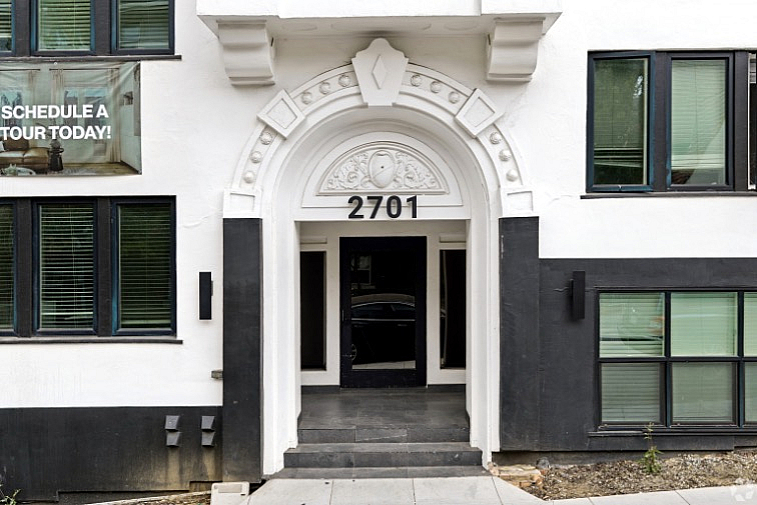 Elegant apartment entrance with ornate arch and modern design at 2701, inviting you to schedule a tour today.
