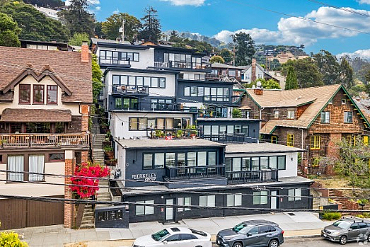 Charming hillside apartments with a mix of modern and traditional architecture, featuring lush greenery and scenic neighborhood views.
