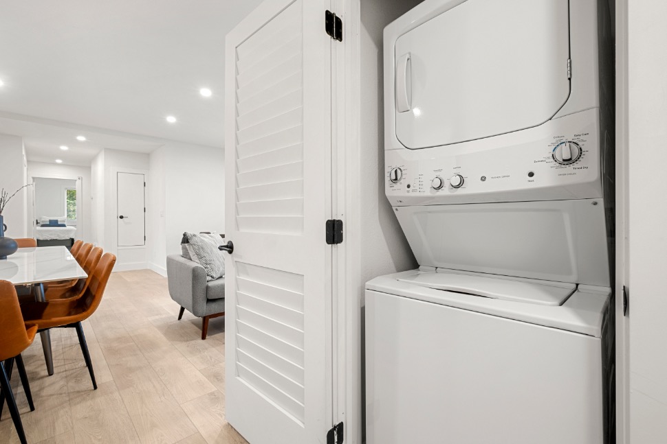 Modern apartment featuring sleek in-unit washer and dryer with bright open-concept design, stylish dining area, and cozy living space.