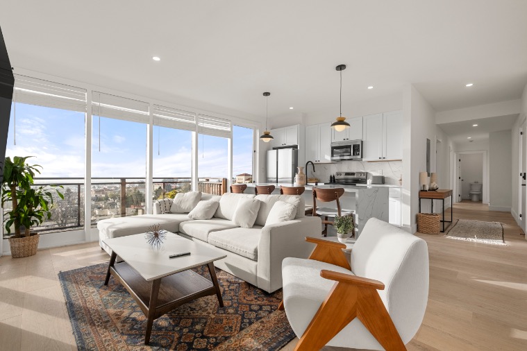Bright, modern living room with panoramic city views, featuring a cozy sofa, stylish chairs, and an open kitchen with sleek finishes.