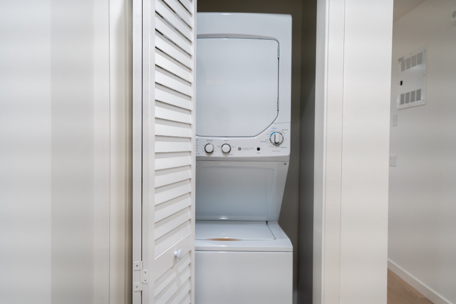 Modern apartment with convenient in-unit stacked washer and dryer in a compact laundry nook.