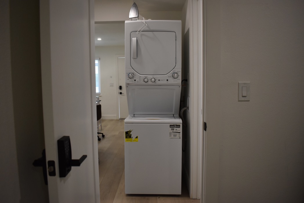 Modern apartment with a convenient in-unit stacked washer and dryer, featuring sleek design and efficient use of space.