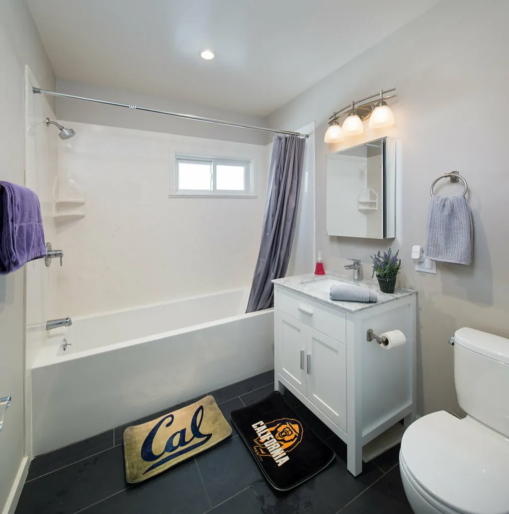 Bright and modern bathroom with a sleek bathtub, elegant white vanity, and stylish decor.