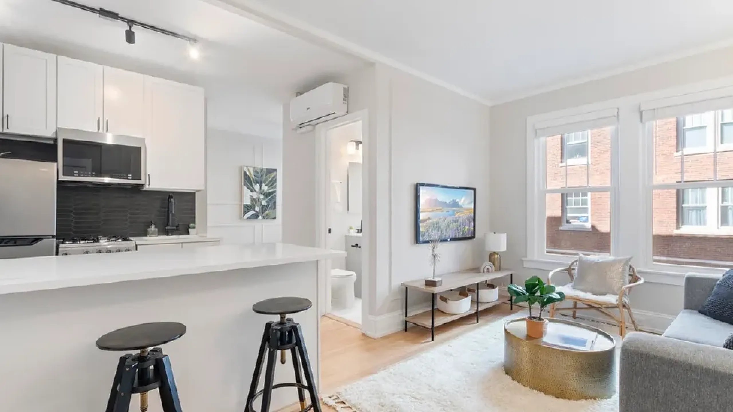 Open concept kitchen and living room with ample natural light