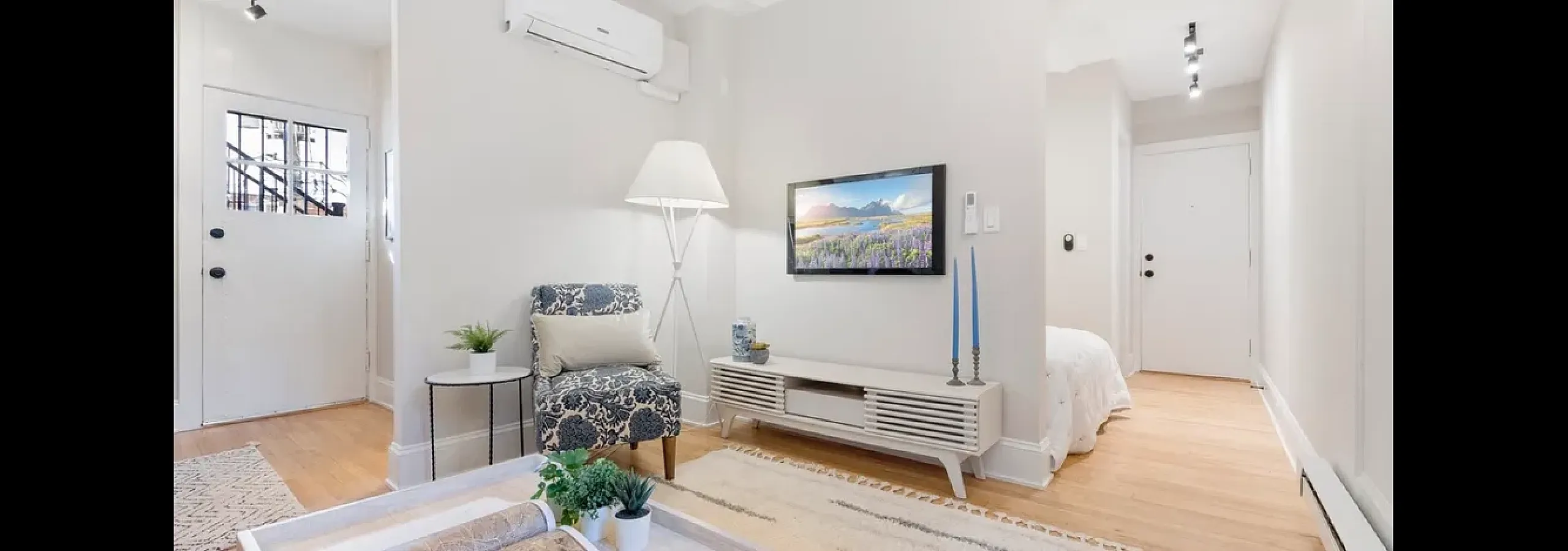 Cozy living room leads to open bedroom nook