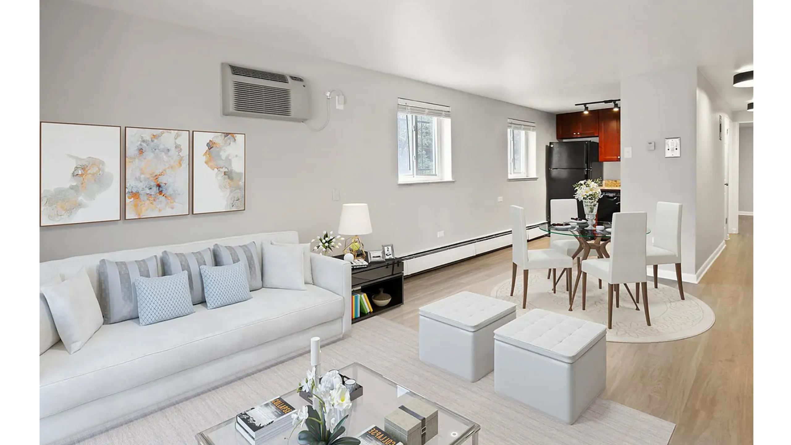 Modern open-concept living area with elegant decor, featuring a cozy sofa, stylish dining set, and contemporary kitchen in a bright, airy apartment.