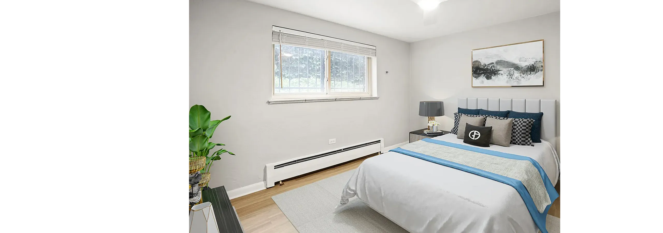 Bright and cozy bedroom with modern decor, featuring a large window, stylish bed set, and elegant artwork, perfect for relaxation.