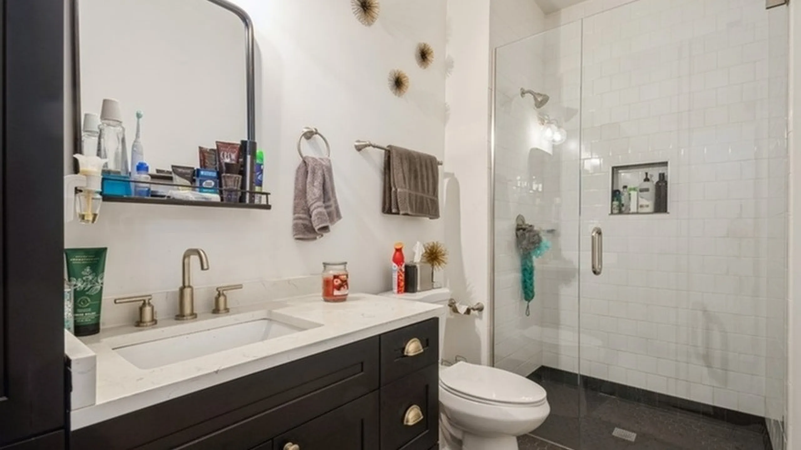 Elegant modern bathroom with a sleek walk-in glass shower, stylish vanity, and contemporary fixtures.