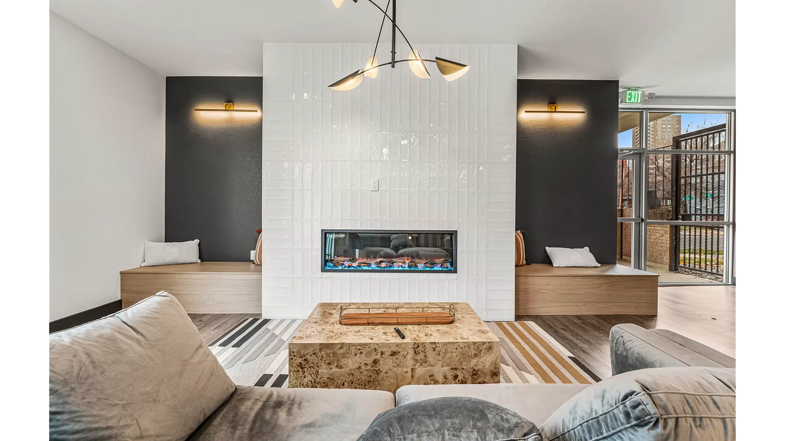 Contemporary living room with elegant fireplace, chic lighting, and plush seating, offering a cozy and stylish relaxation space.