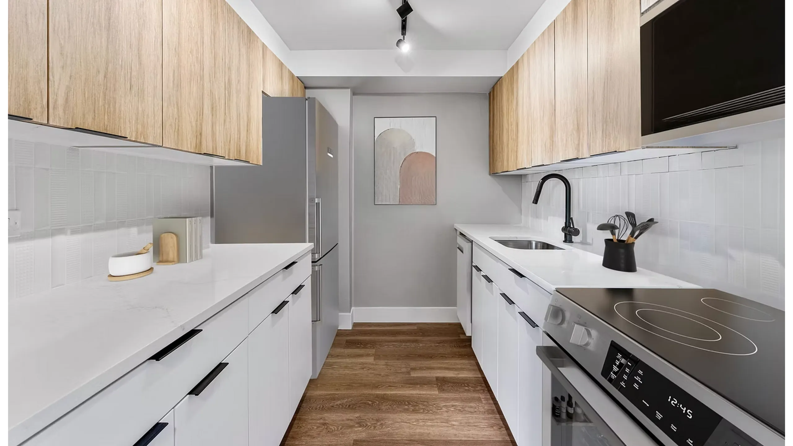 Sleek modern kitchen with stylish wood cabinets, pristine white countertops, and state-of-the-art appliances for a contemporary living experience.