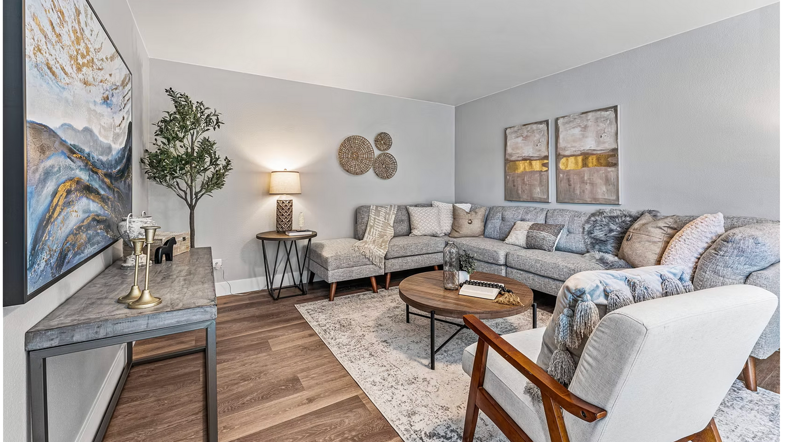 Inviting living room featuring a plush sectional sofa, modern decor, and elegant artwork, perfect for relaxation and entertainment.