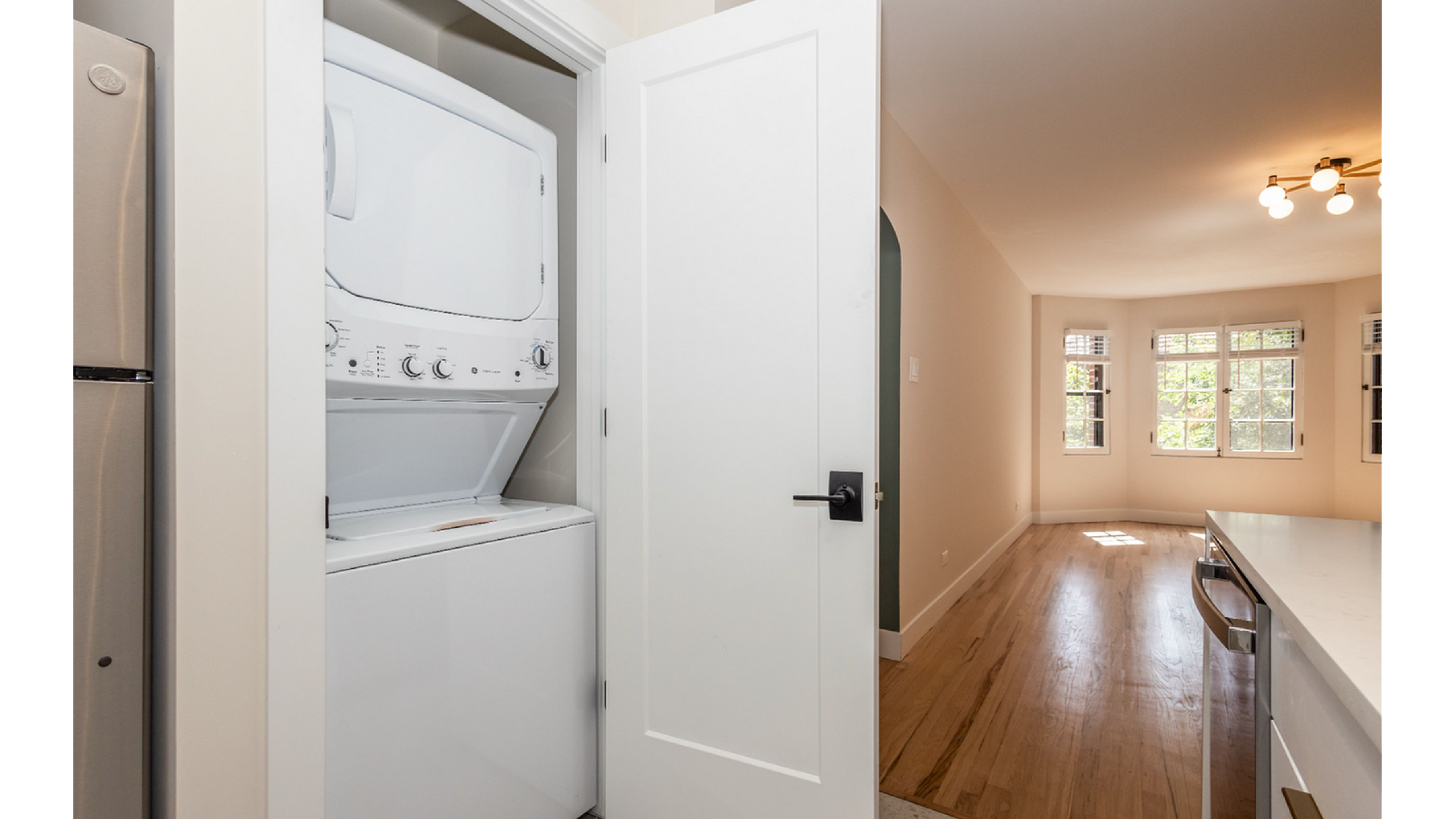 Chic apartment interior with modern in-unit laundry, elegant lighting, and bright natural light filling the living area.
