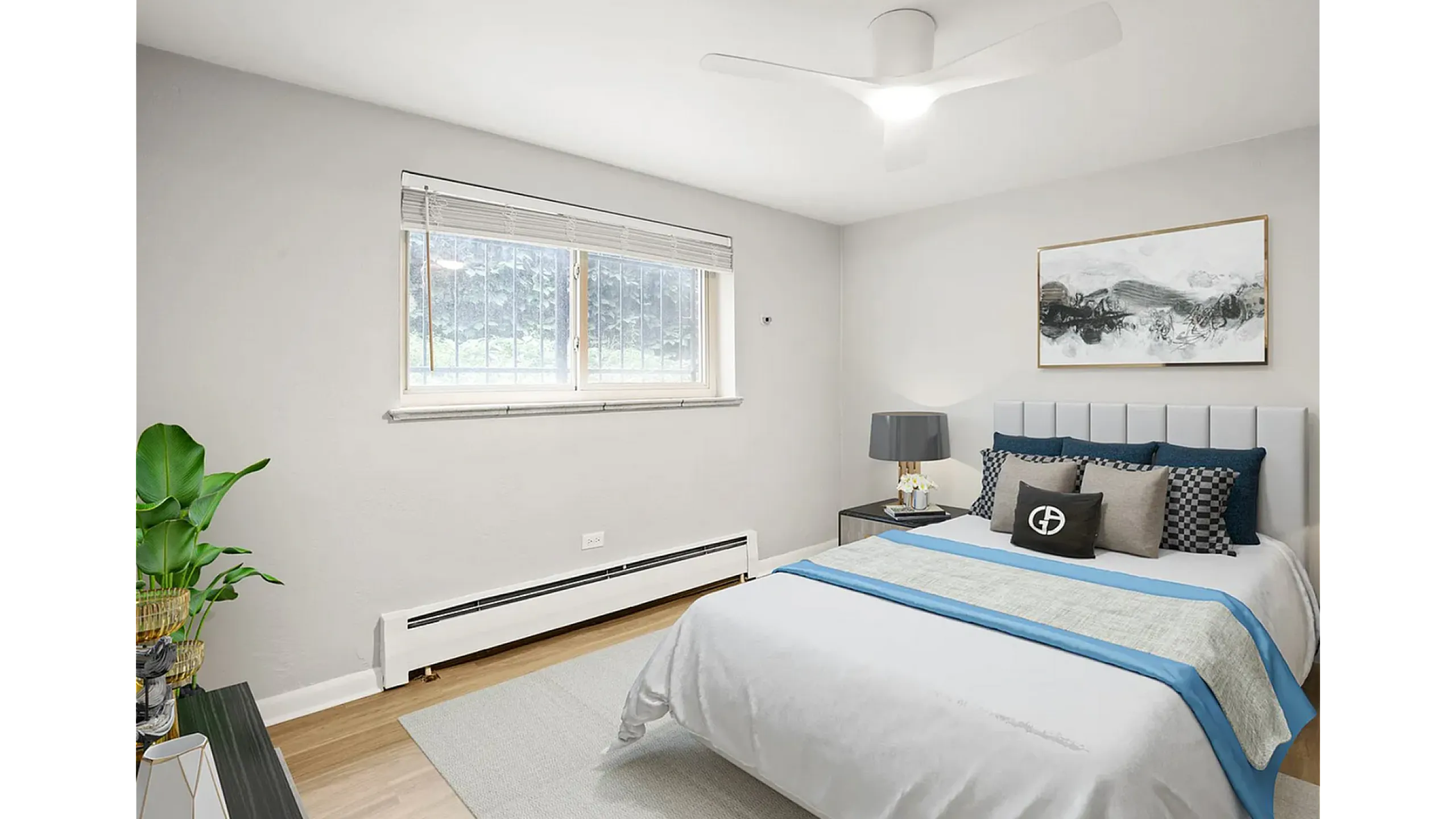 Bright and airy bedroom with stylish decor, featuring a plush bed, contemporary artwork, and a large window with natural light.