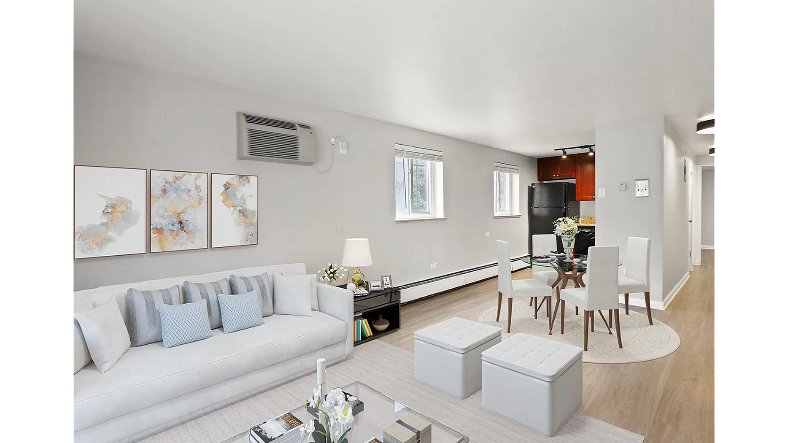 Chic and modern open-concept living room with sleek decor, a comfy couch, and inviting dining area, showcasing bright natural light.