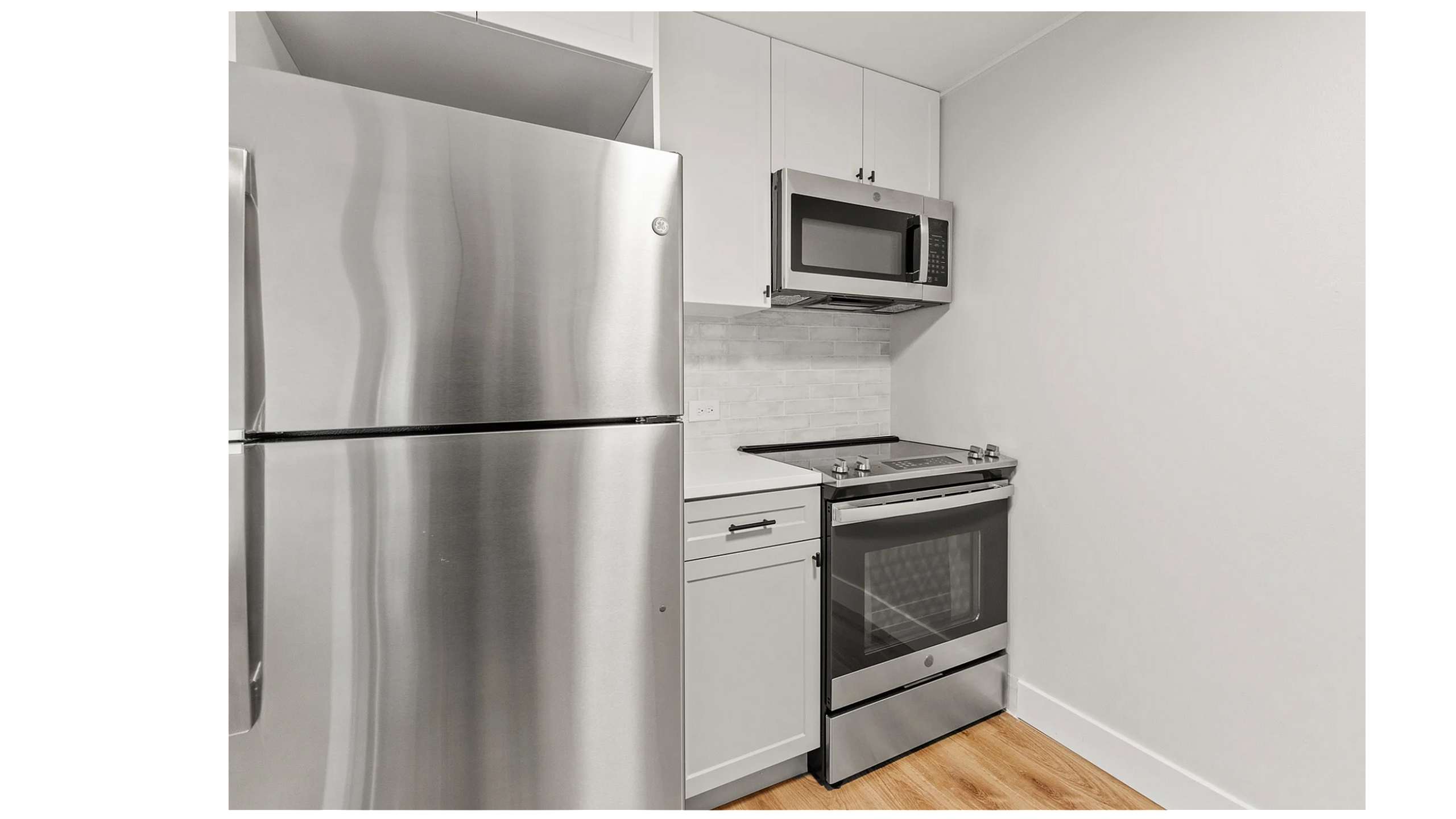 Modern kitchen featuring sleek stainless steel appliances and elegant white cabinetry, perfect for culinary enthusiasts.