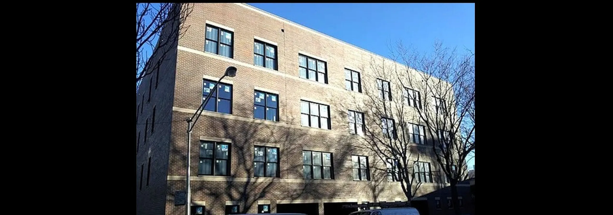 Elegant urban apartment building showcasing modern design with large windows and inviting street appeal.