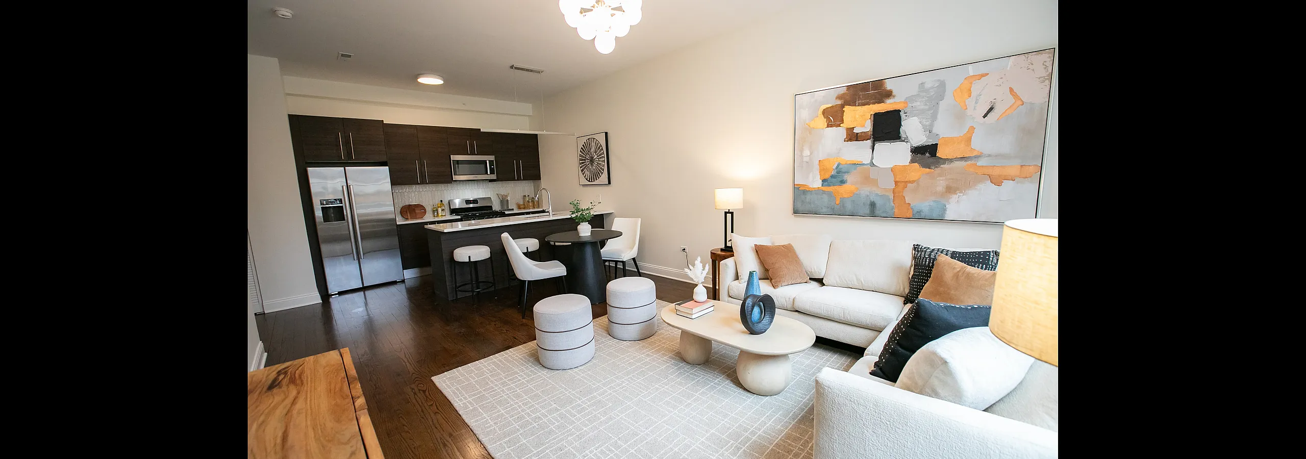 Chic open-concept living space with modern kitchen, elegant dining area, and cozy lounge adorned with stylish decor.
