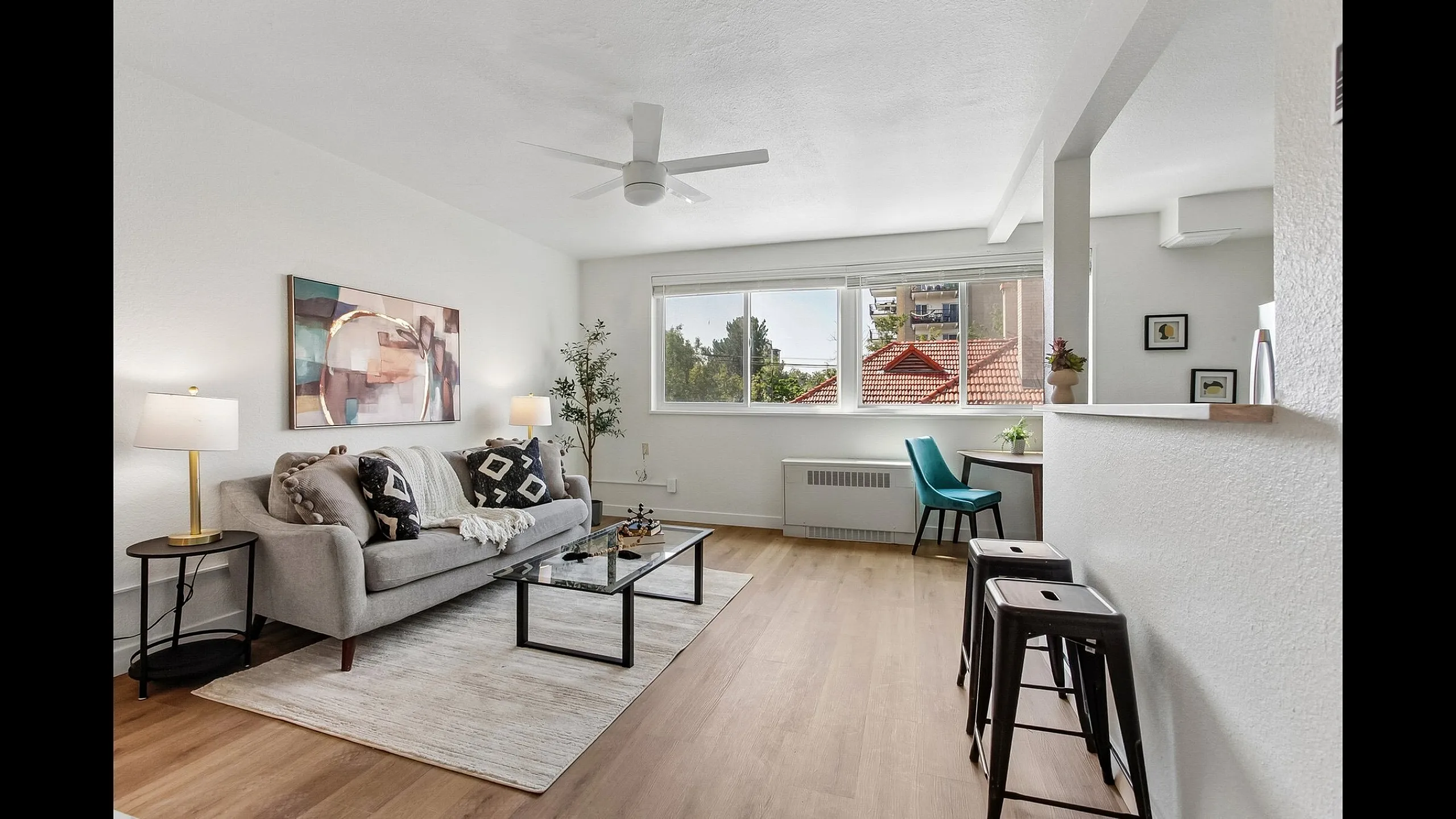 Bright and inviting living room with modern decor, featuring a cozy sofa, stylish coffee table, and large window offering abundant natural light.