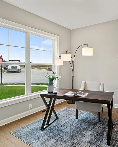 Bright and inviting home office space with large window, sleek desk, and contemporary decor.