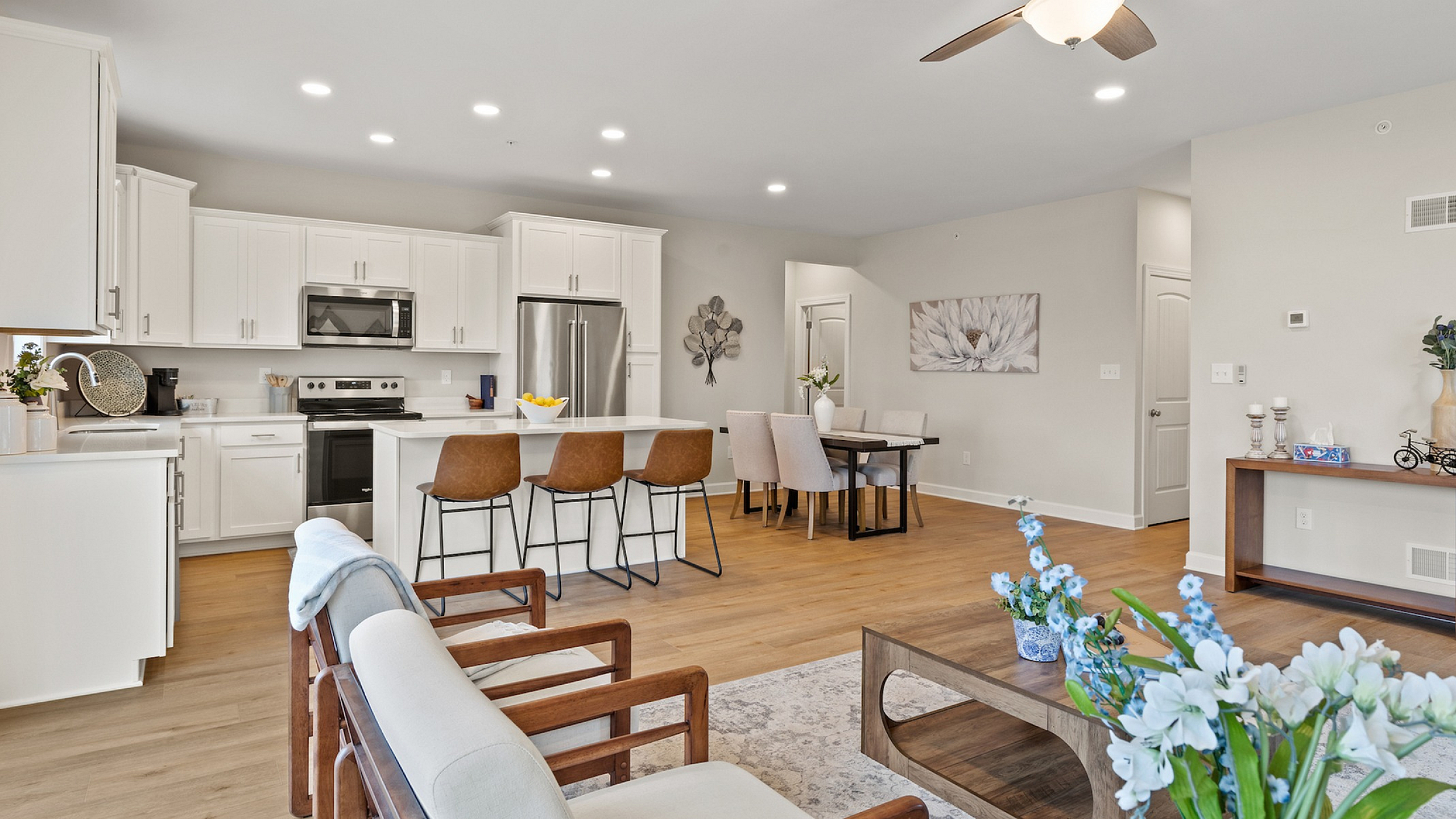 Inviting open-concept living space with modern kitchen, cozy dining area, and elegant wooden accents showcasing stylish home design.