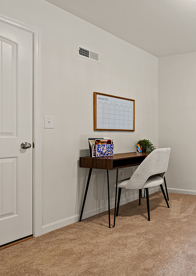 Bright and inviting office nook with modern desk, elegant chairs, and vibrant artwork, perfect for productivity and style.