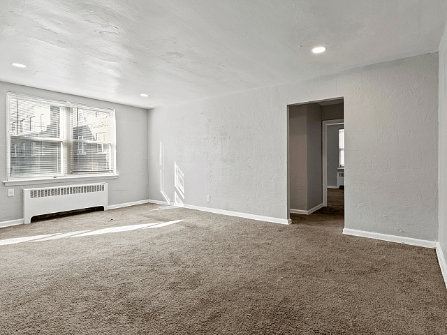 Bright and spacious living room with large windows, inviting natural light and a serene atmosphere.
