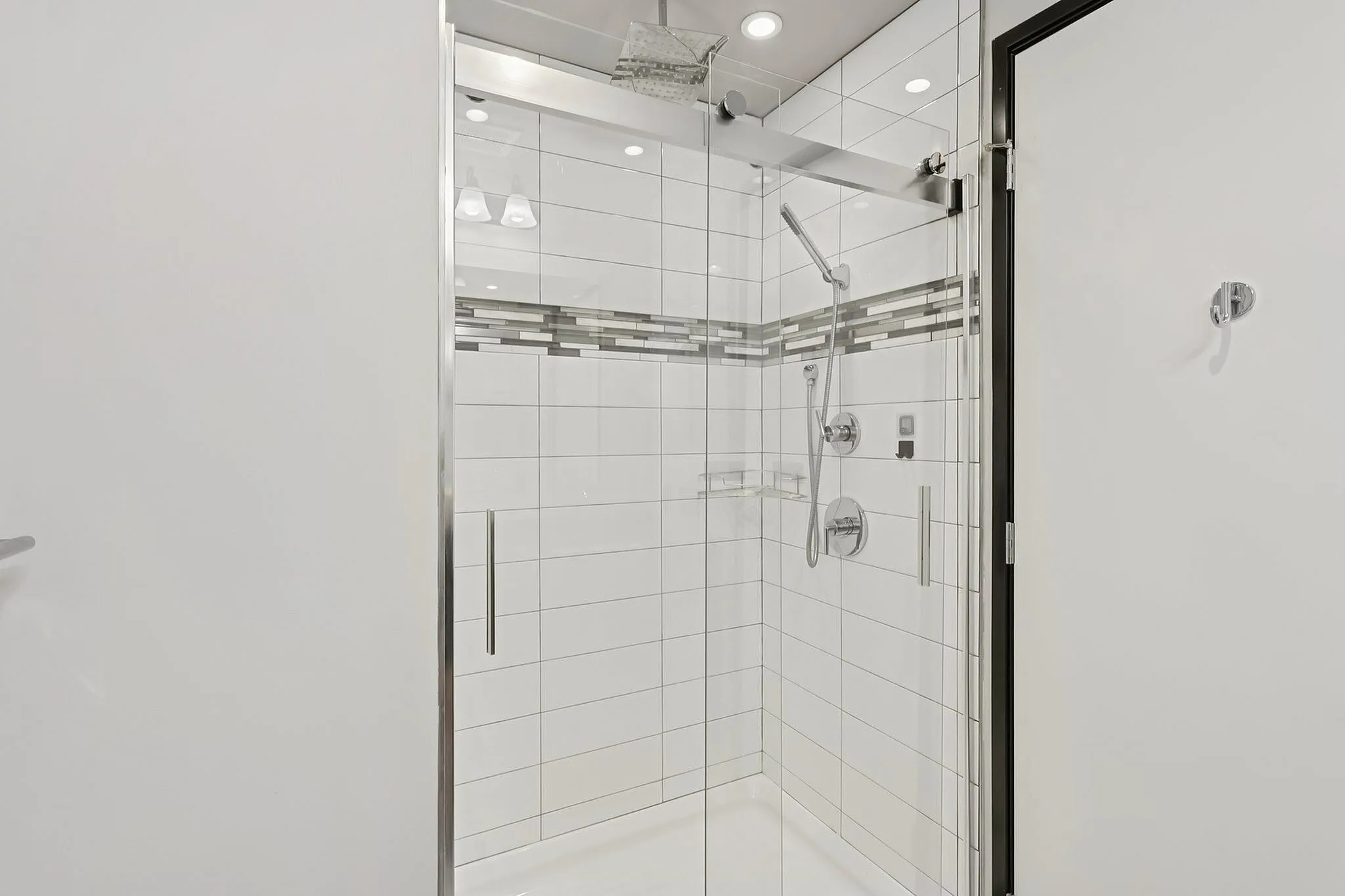 Sleek modern shower with elegant glass enclosure and stylish tile accents.